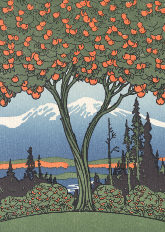 An orange tree stands in front of a snow-capped mountain. 